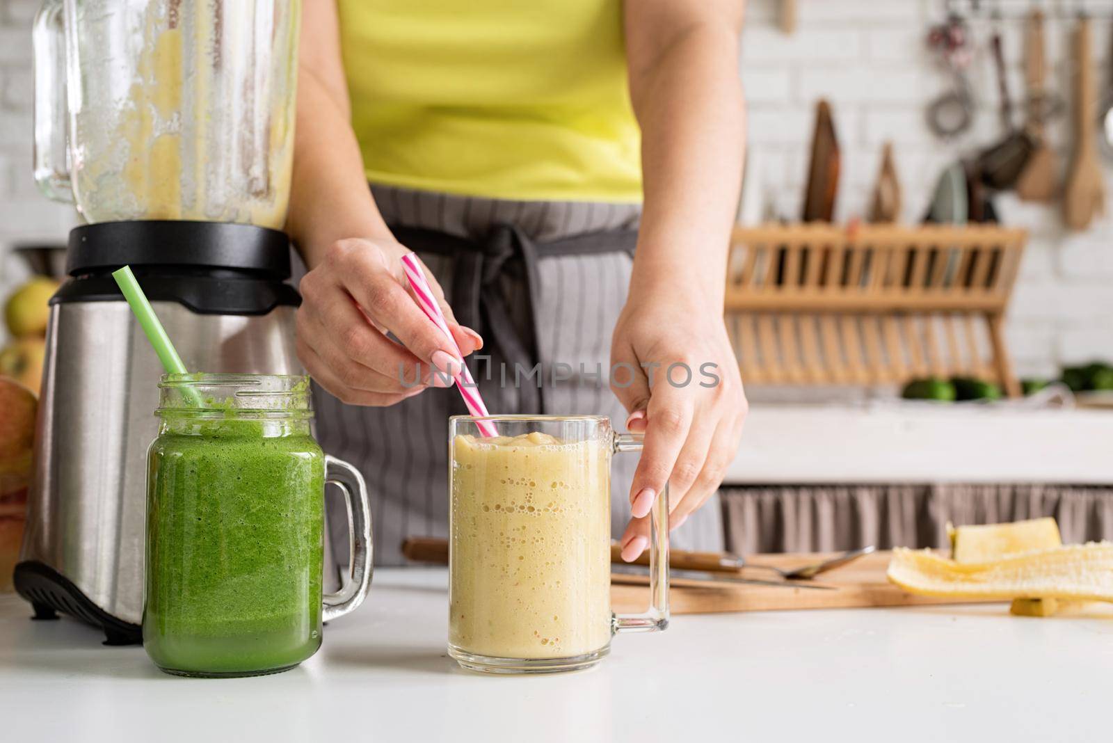 Healthy eating, dieting concept. Close up of a young woman holding a jar of fruit smoothie