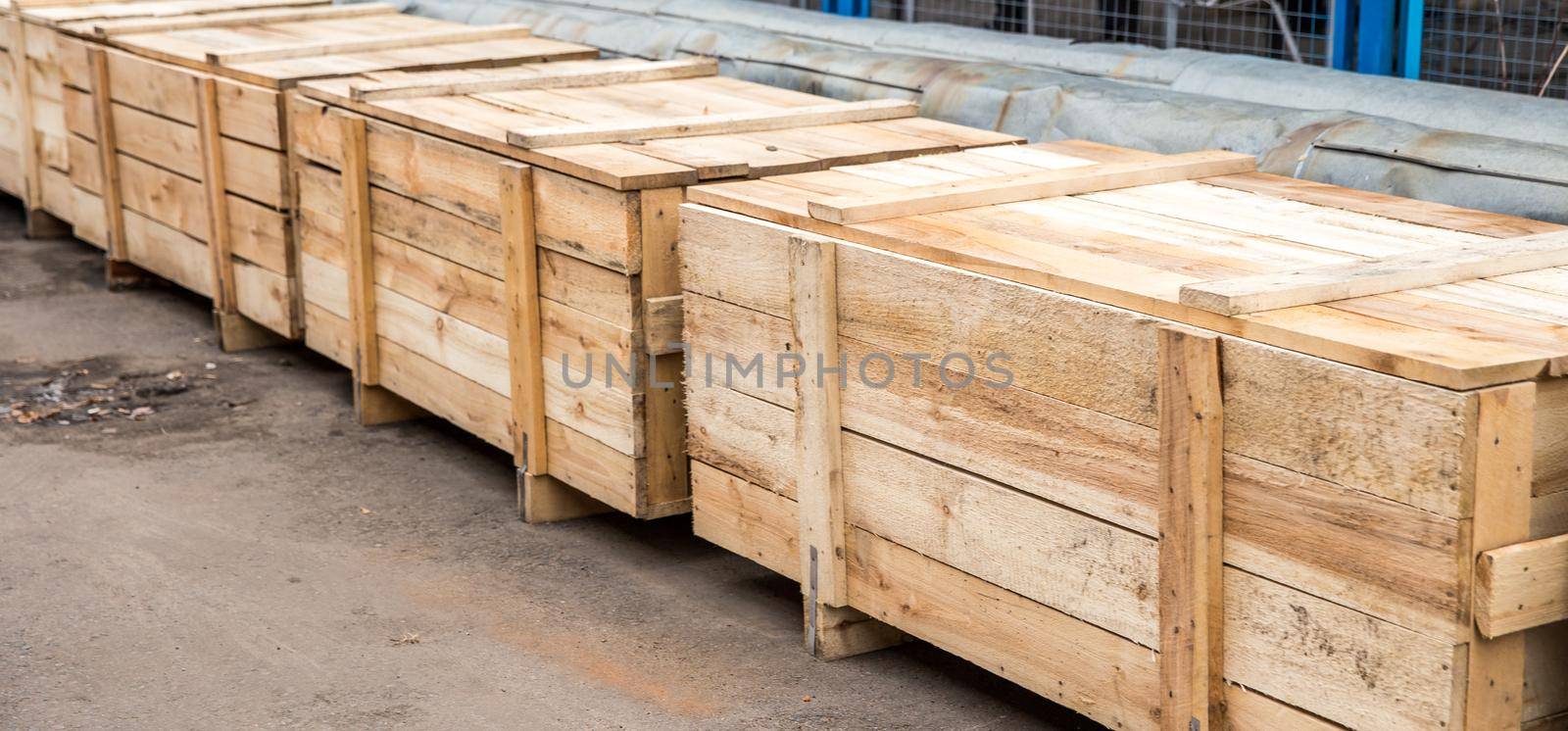 Many big wooden cargo containers standing outdoors ready to be shipped