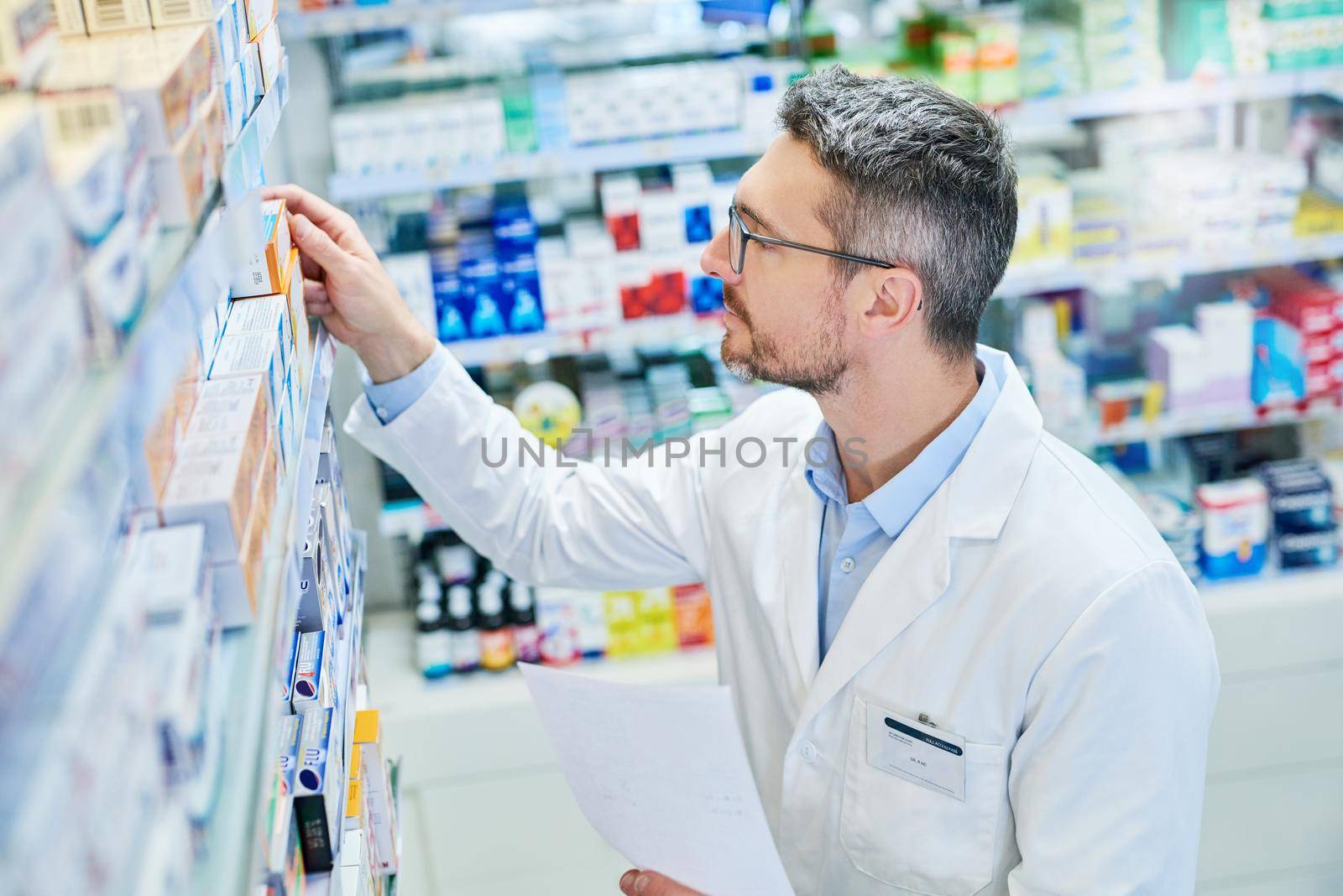 We have what the doctor prescribed. Shot of a mature pharmacist working in a pharmacy. by YuriArcurs