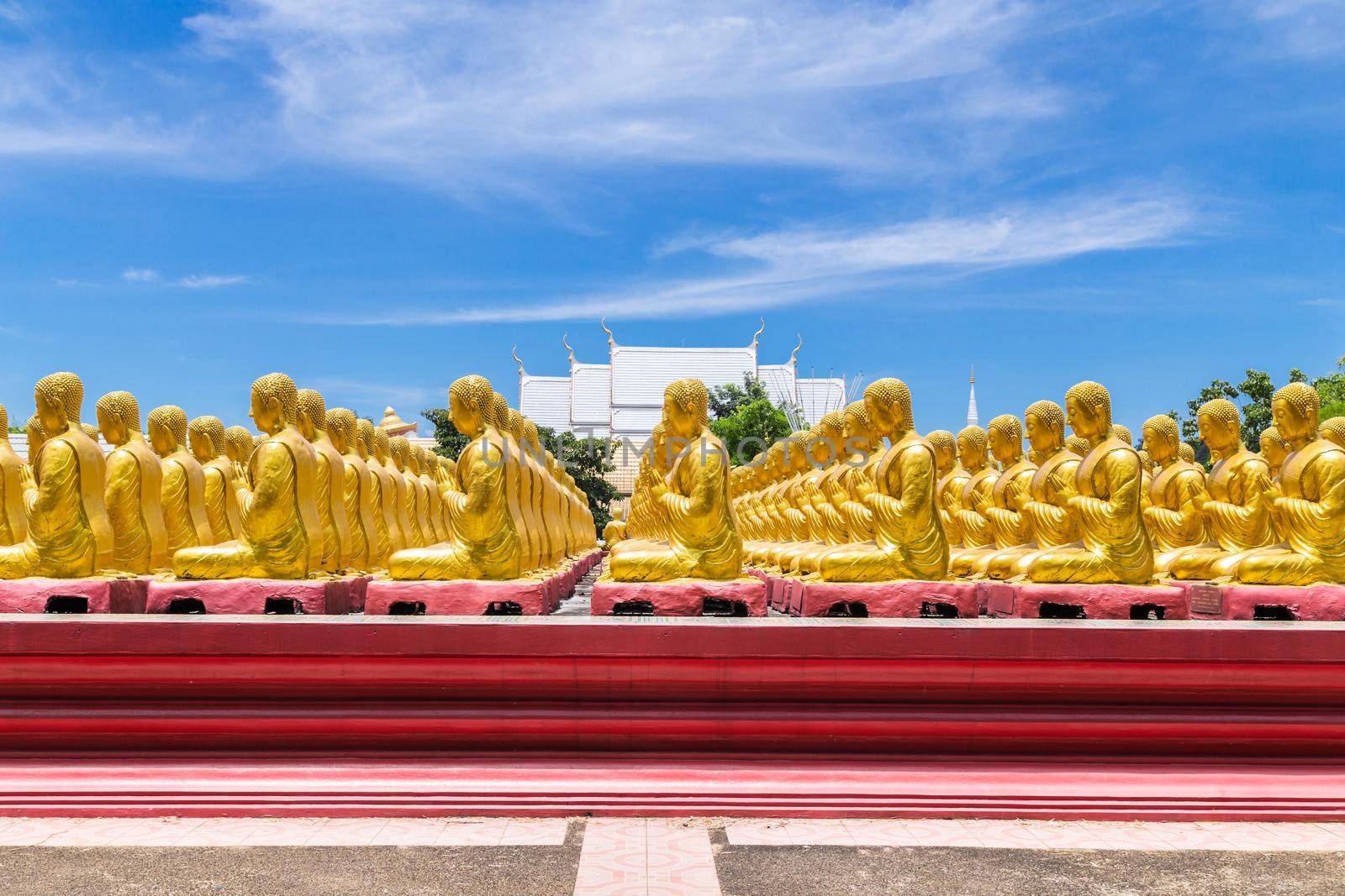 Row of disciple statues surrounding big buddha statue in public to the general public worship worship of Nakhon Nayok, Thailand.