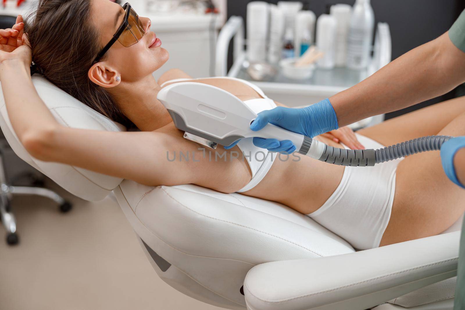 Armpit hair laser removal procedure with ipl machine in a beauty salon by Yaroslav_astakhov