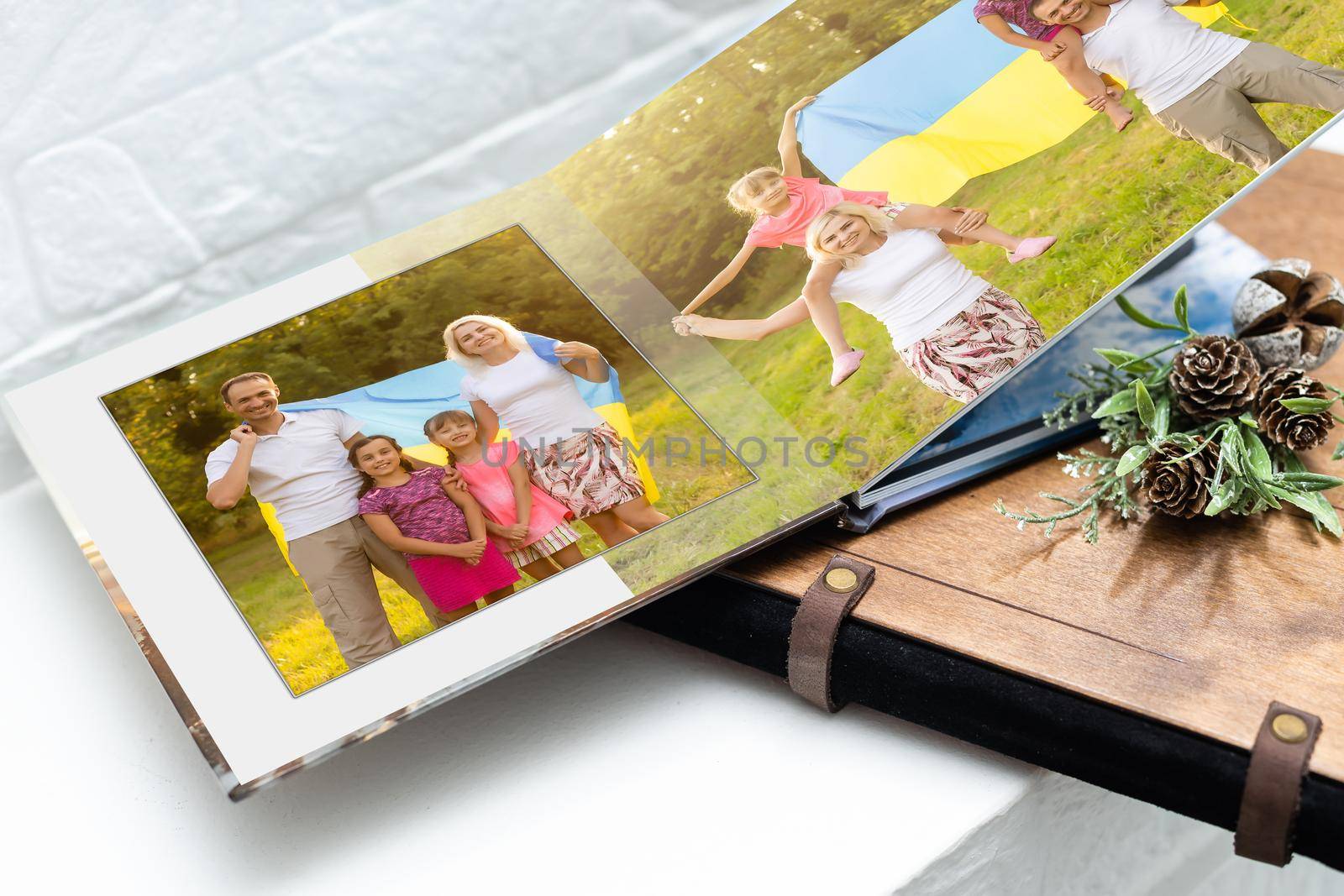 Family photos archive saved in brightly designed photo book; bright summer memories placed in the photobook. family with flag of ukraine by Andelov13