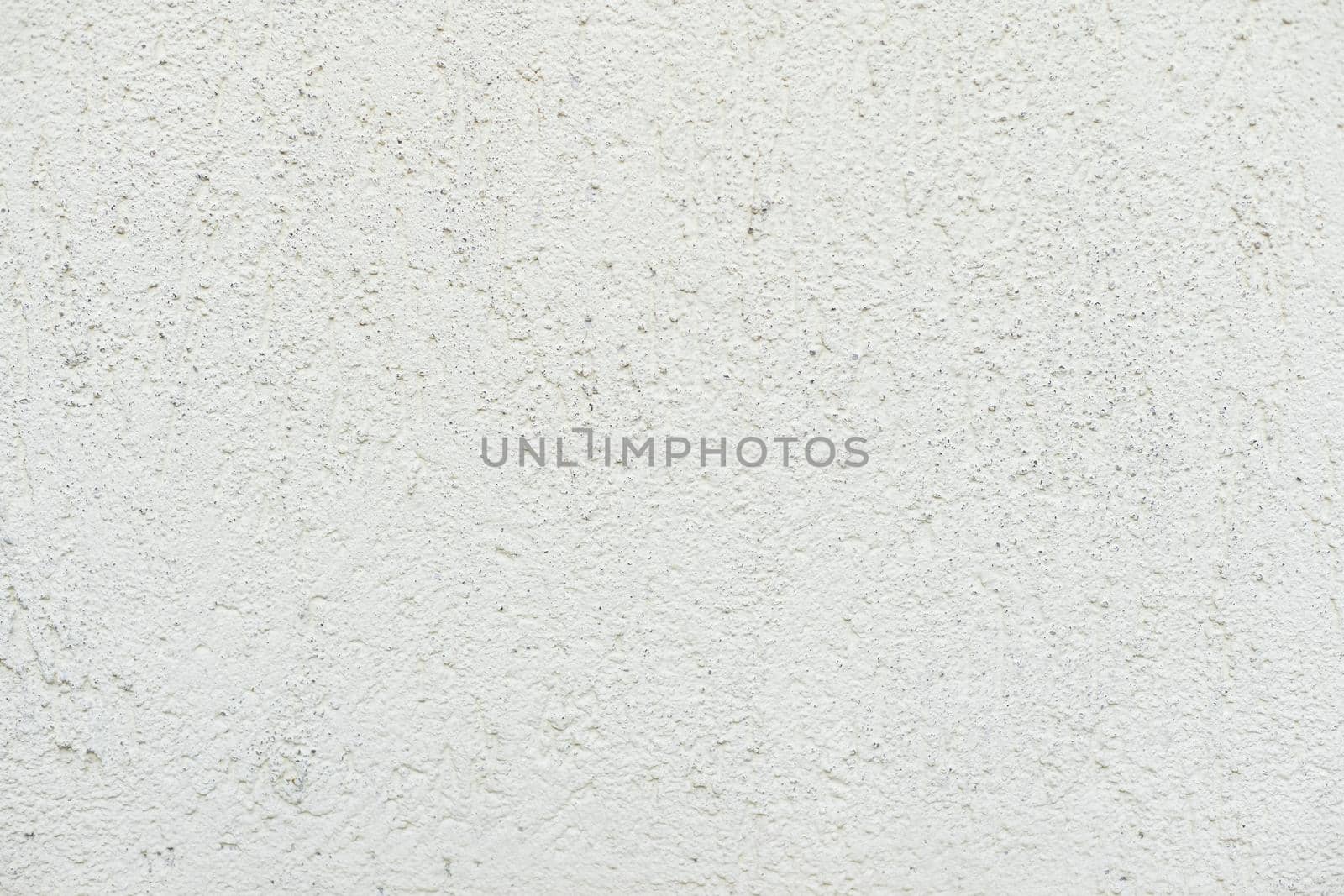Pattern of light beige decorative and textured plaster. Construction and finishing materials for repairs of walls in apartments, houses and offices. Background and texture for design and decoration.