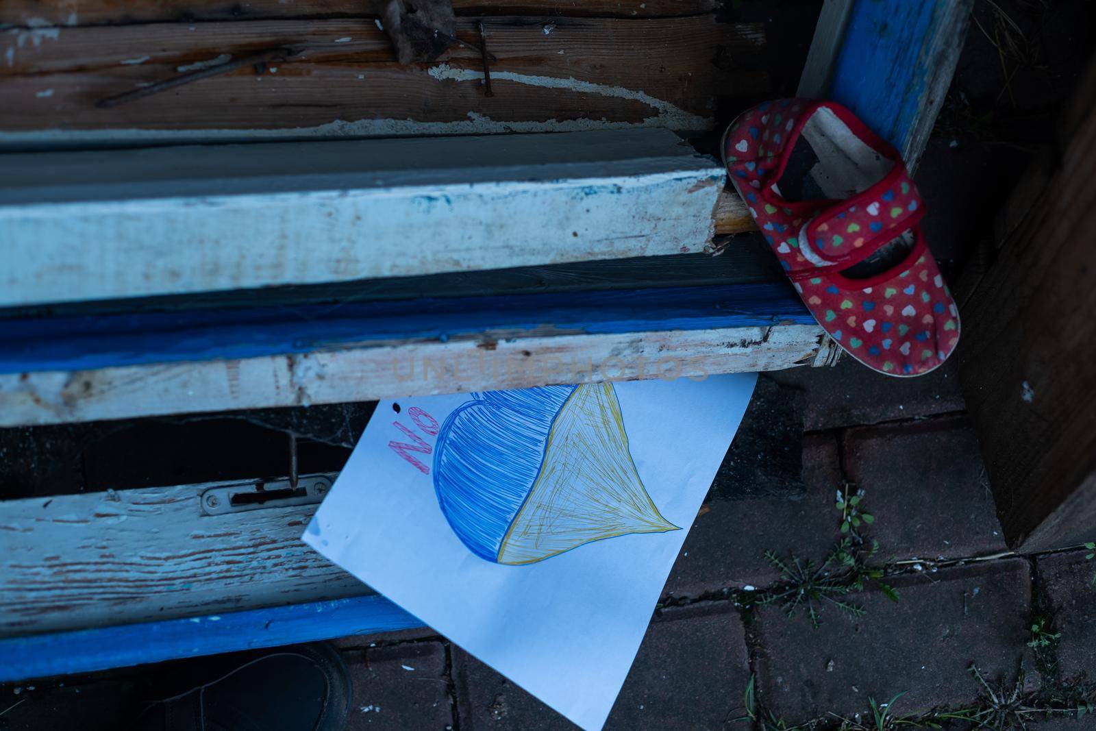 children's shoes and the flag of Ukraine, the war.