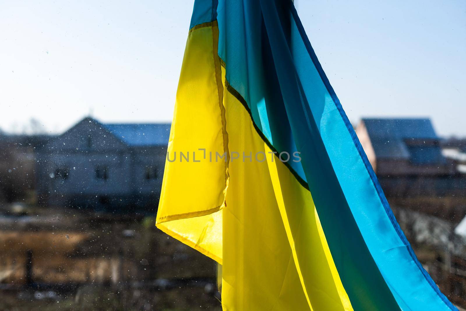 Support Ukraine. Ukrainian flag on the window. Place for text. by Andelov13