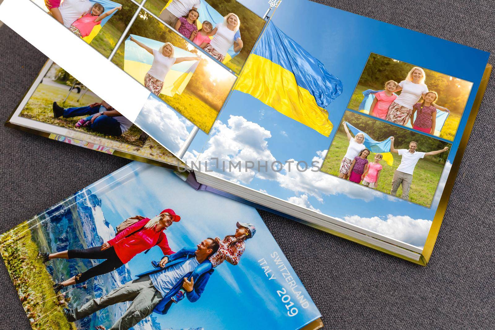 on white table open photobook from photo shoot of family with ukraine flag.