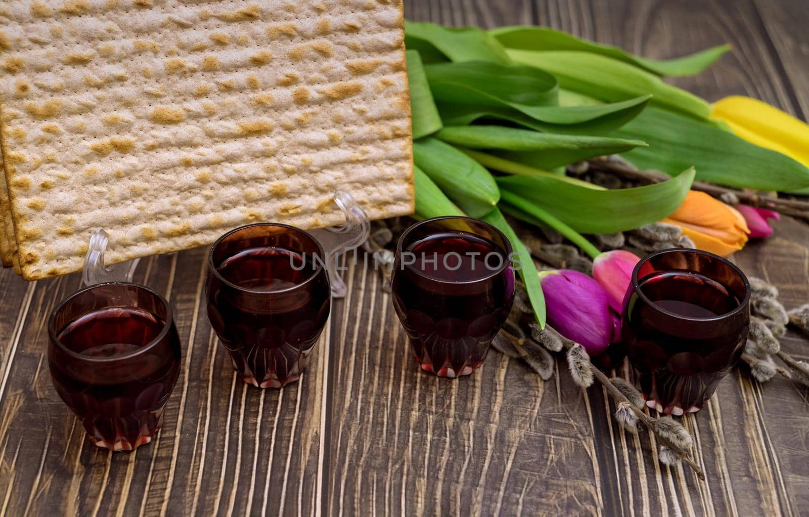 Jewish traditional Passover holiday celebration of kosher wine four cup and matzah bread on Pesach