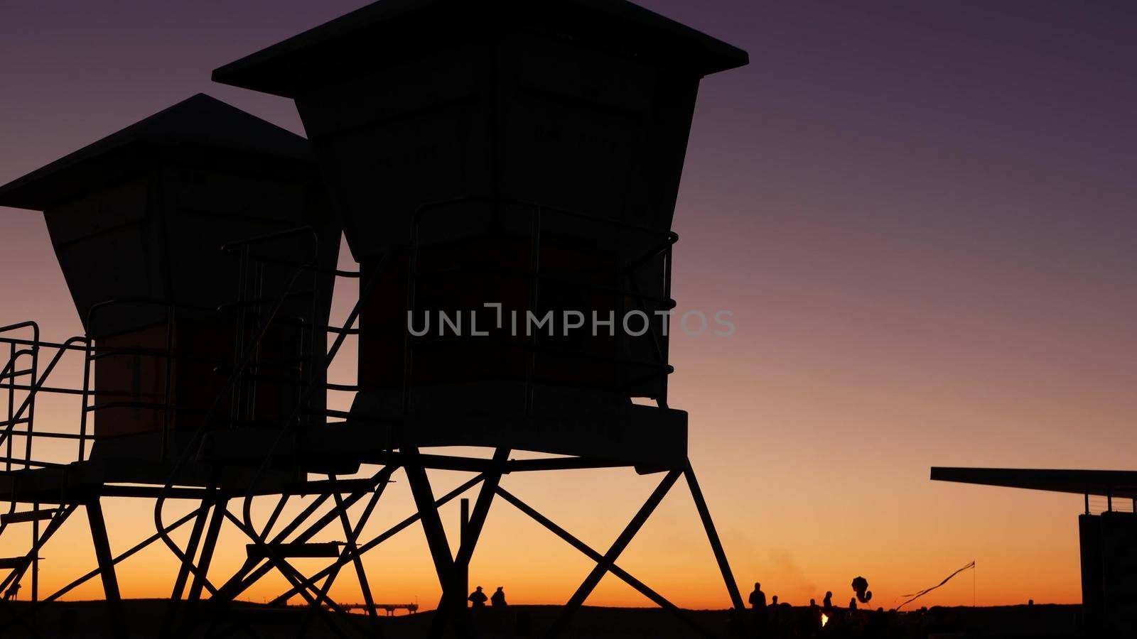 Lifeguard stand, hut or house on ocean beach after sunset, California coast, USA by DogoraSun
