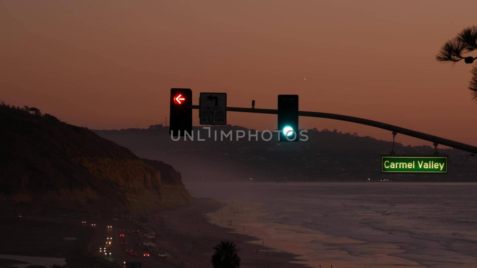Traffic lights, pacific coast highway 1, Torrey Pines state beach, Del Mar, San Diego, California USA. Coastal road trip vacations. Roadtrip along ocean, freeway 101. Carmel Valley sign, twilight dusk