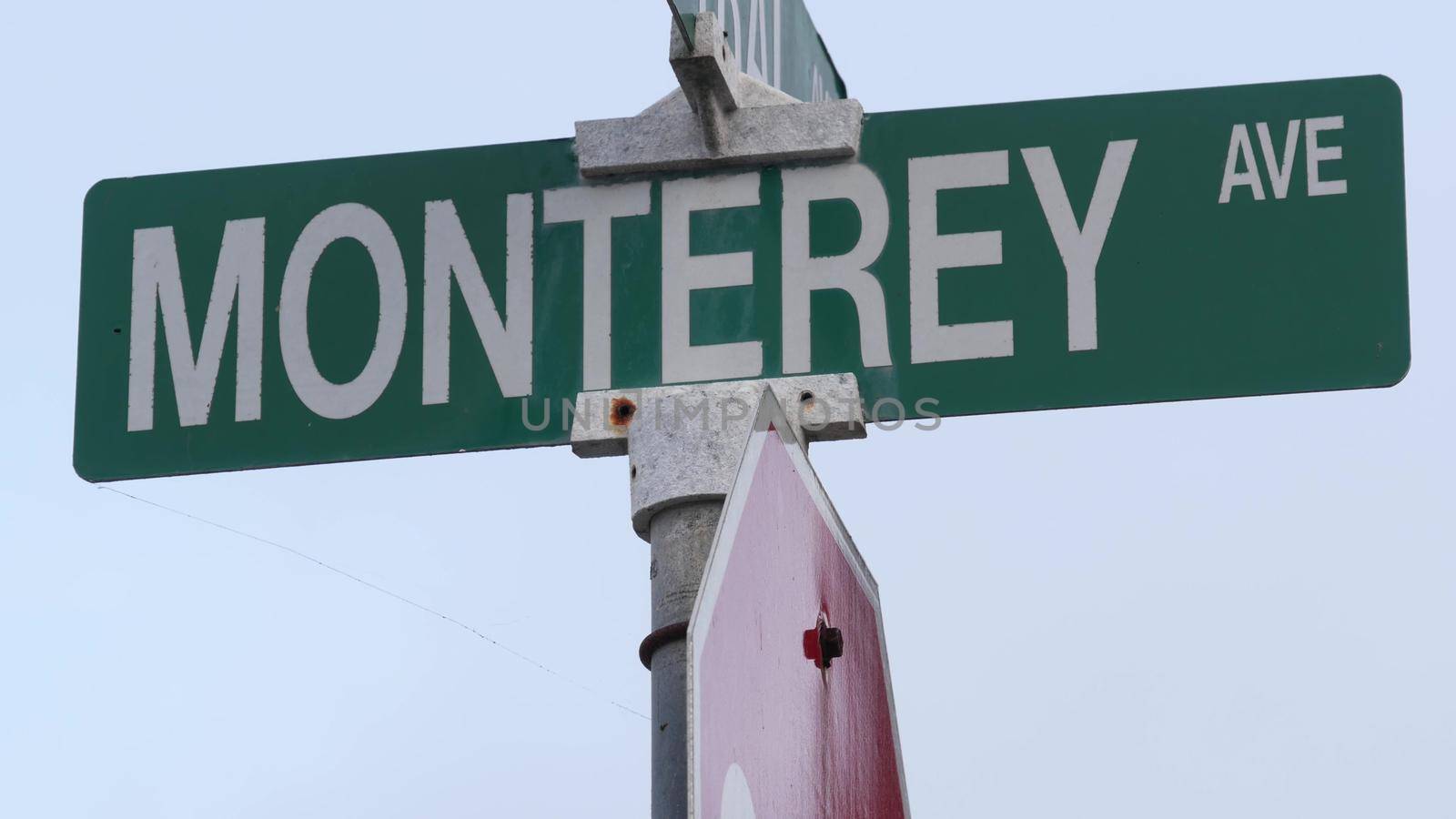 Monterey road sign, California street crossroad, USA. Tourist resort, historic capital. Waterfront travel destination for coastal summer vacations. 17-mile drive, Bay Aquarium and Cannery Row city.