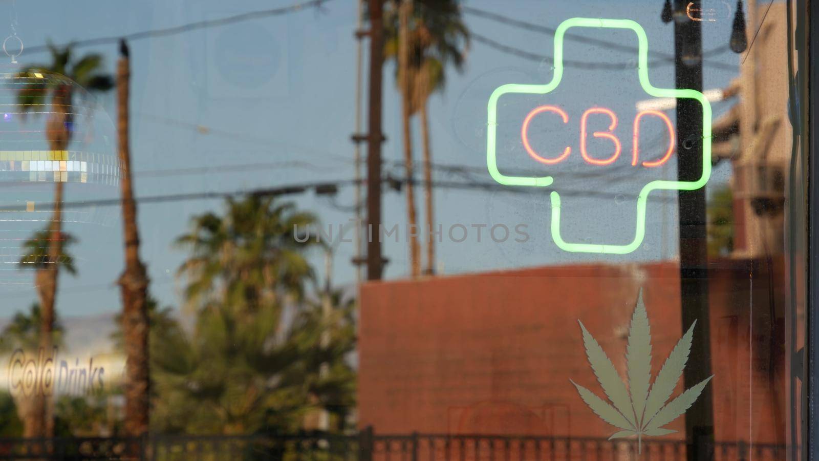 Neon sign in smoke shop, legalized cbd oil or medical cannabis in store, California USA. Legal sale of cannabidiol, weed, hemp, marijuana, ganja or hashish in dispensary. Cannabinoids in drugstore.