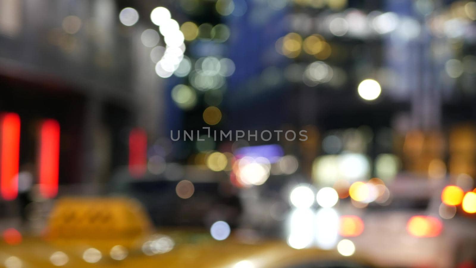 Defocused cars lights on road in twilight, vehicles traffic on megapolis street. Urban downtown, business or financial district of Moscow, Russia. Transport driving, big city life. Yellow taxi cab.