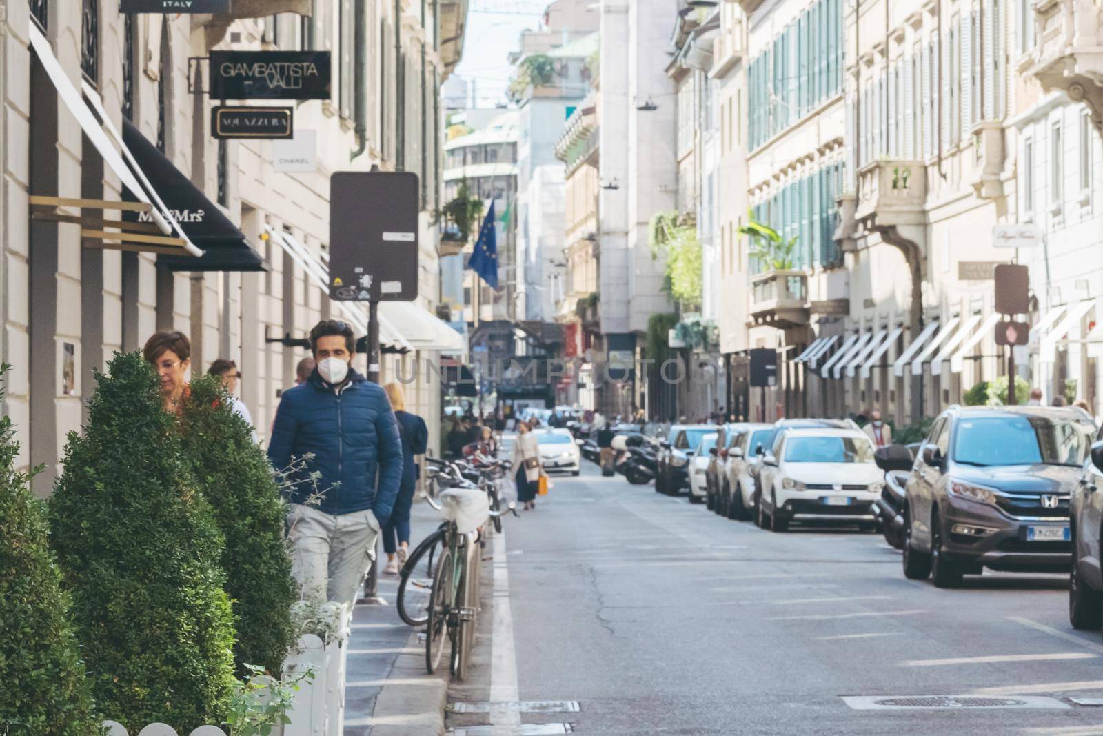 Milan, Italy - September 24, 2020. People walking downtown in facial medical masks. New normal. People wearing face mask and maintain social distancing. Italy in coronavirus COVID-19 lockdown