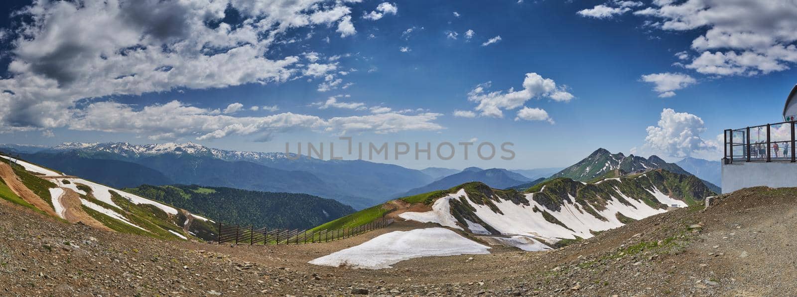 Summer panorama of mountains from 2320 meters, an observation deck, the top point of ski slopes in Sochi, the snow remains on slopes. High quality photo