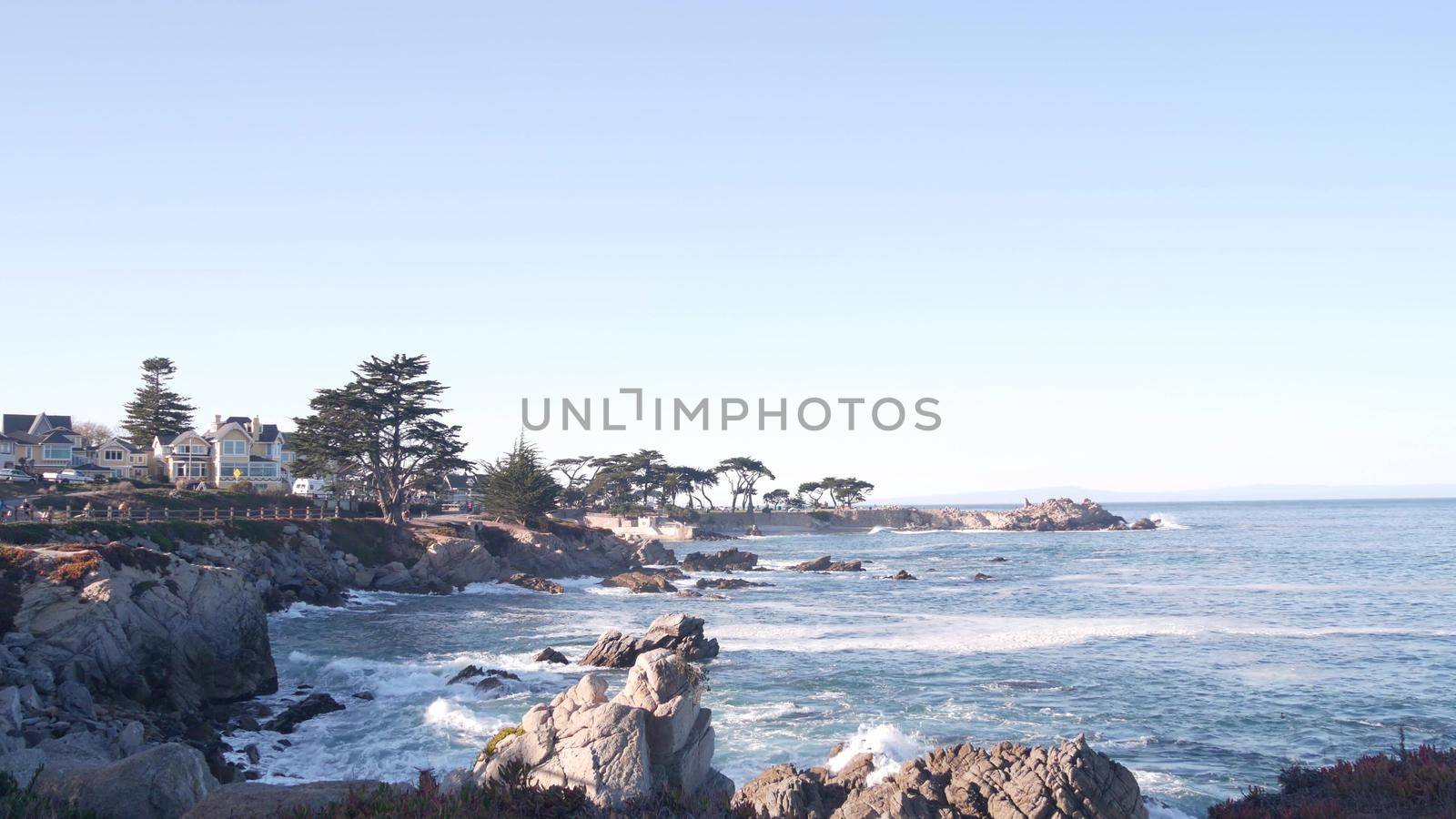 Rocky craggy ocean beach, sea waves crashing on shore, Monterey California coast by DogoraSun