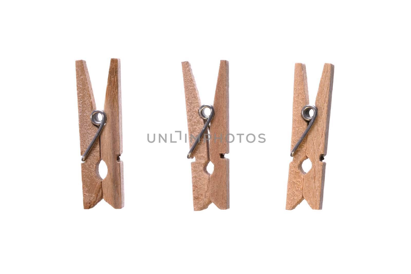 Set of decorative wood beige clothespins isolated on white background. Macro, closeup by photolime