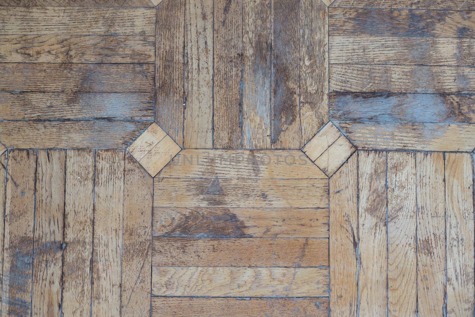 Texture of old worn parquet floor, close up.