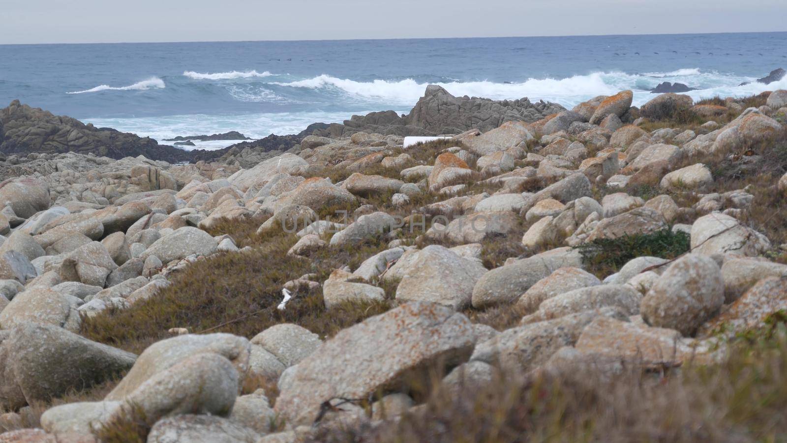 Rocky craggy ocean coast, sea water waves crashing on rocks, Monterey California by DogoraSun