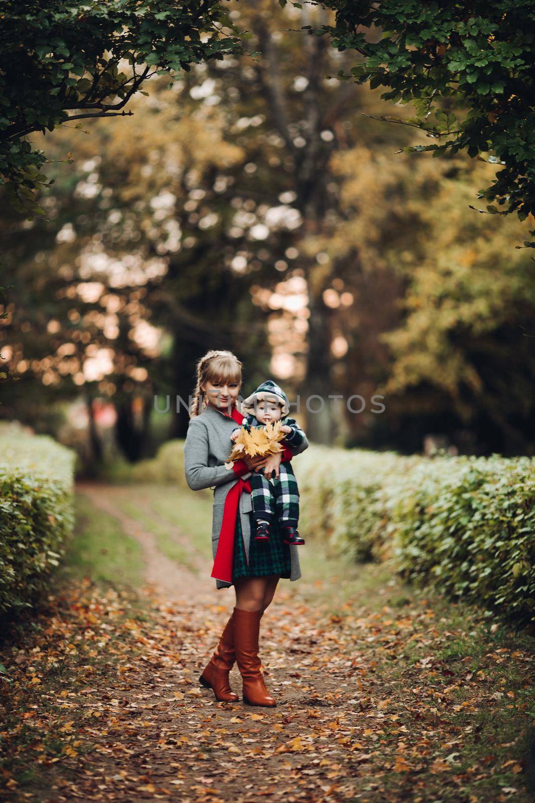 Beautiful caucasian mother with braid embracing her daughter. by StudioLucky