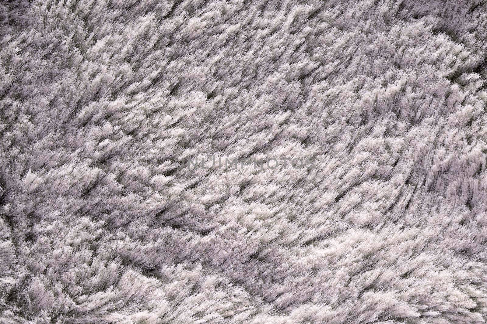 Artificial fur texture for background close-up. Fluffy grey material backdrop. by photolime