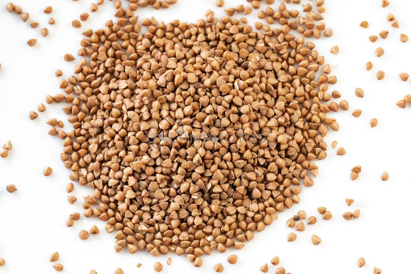 Buckwheat grains. Pile of buckwheat isolated on white background. Top view. The concept of diet and healthy eating, the background texture of the buckwheat. Buckwheat. by photolime