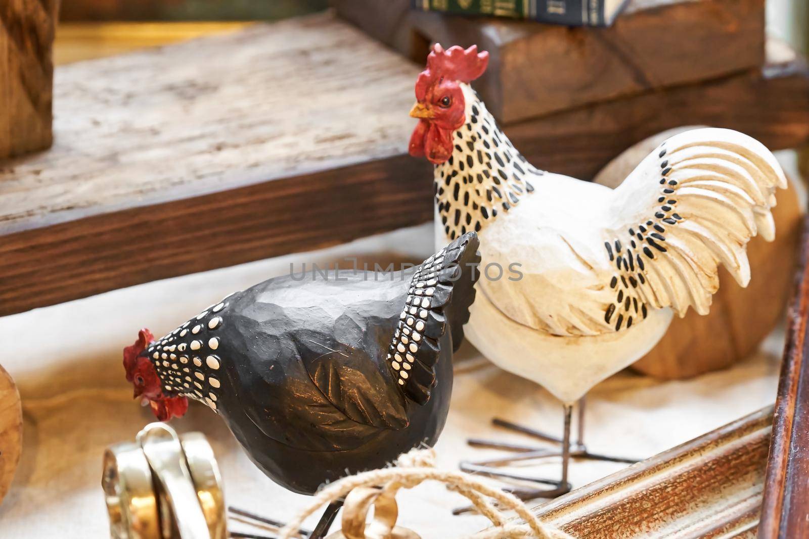 Cock and chicken toy wooden figurine on street market by photolime