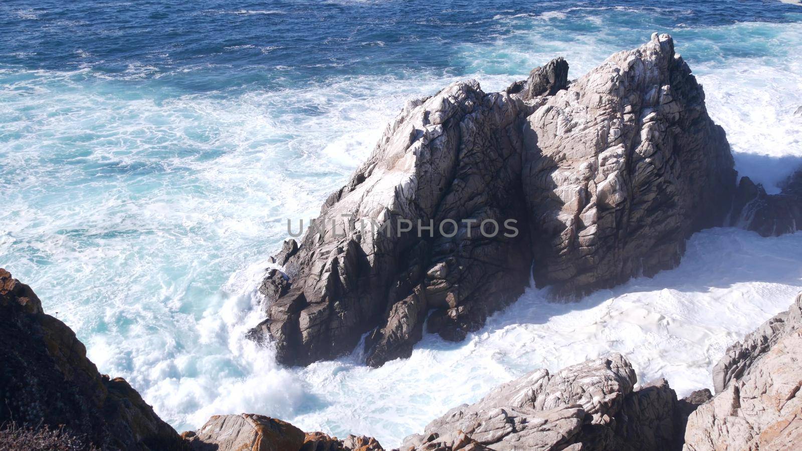 Rock crag of cliff, ocean beach, Point Lobos, California coast. Waves crashing. by DogoraSun