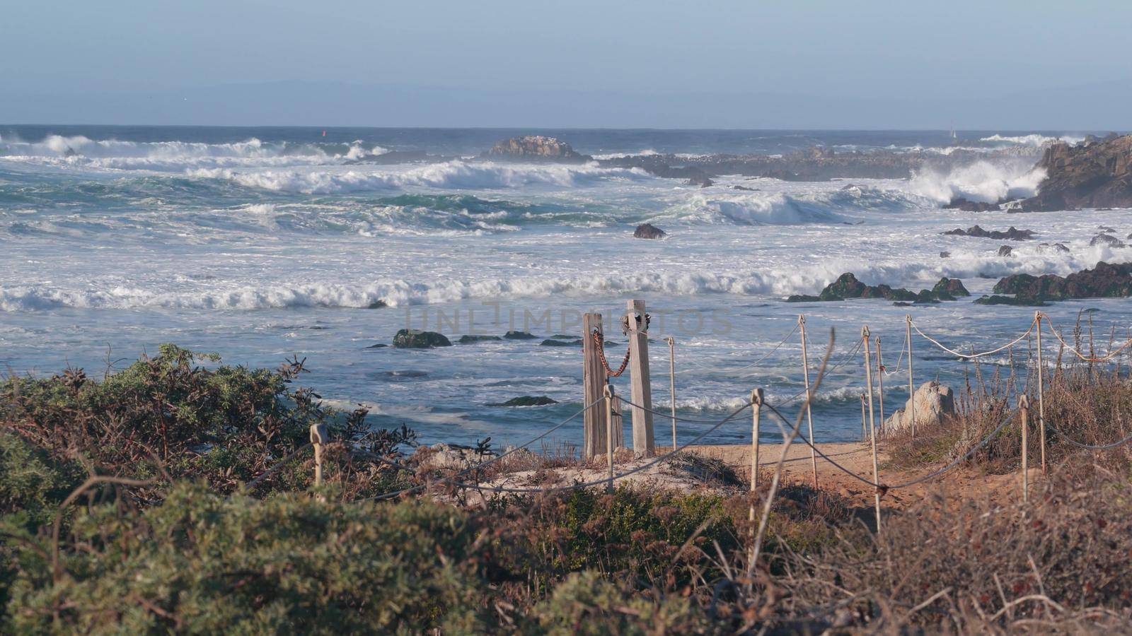 Big huge stormy sea waves crashing on rocky craggy beach, California ocean coast by DogoraSun