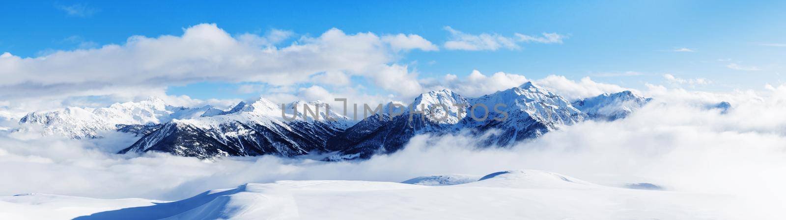 Panoramic view of mountains near Brianson, Serre Chevalier resort, France. Ski resort landscape on clear sunny day. Mountain ski resort. Snow slope. Snowy mountains. Winter vacation. by photolime