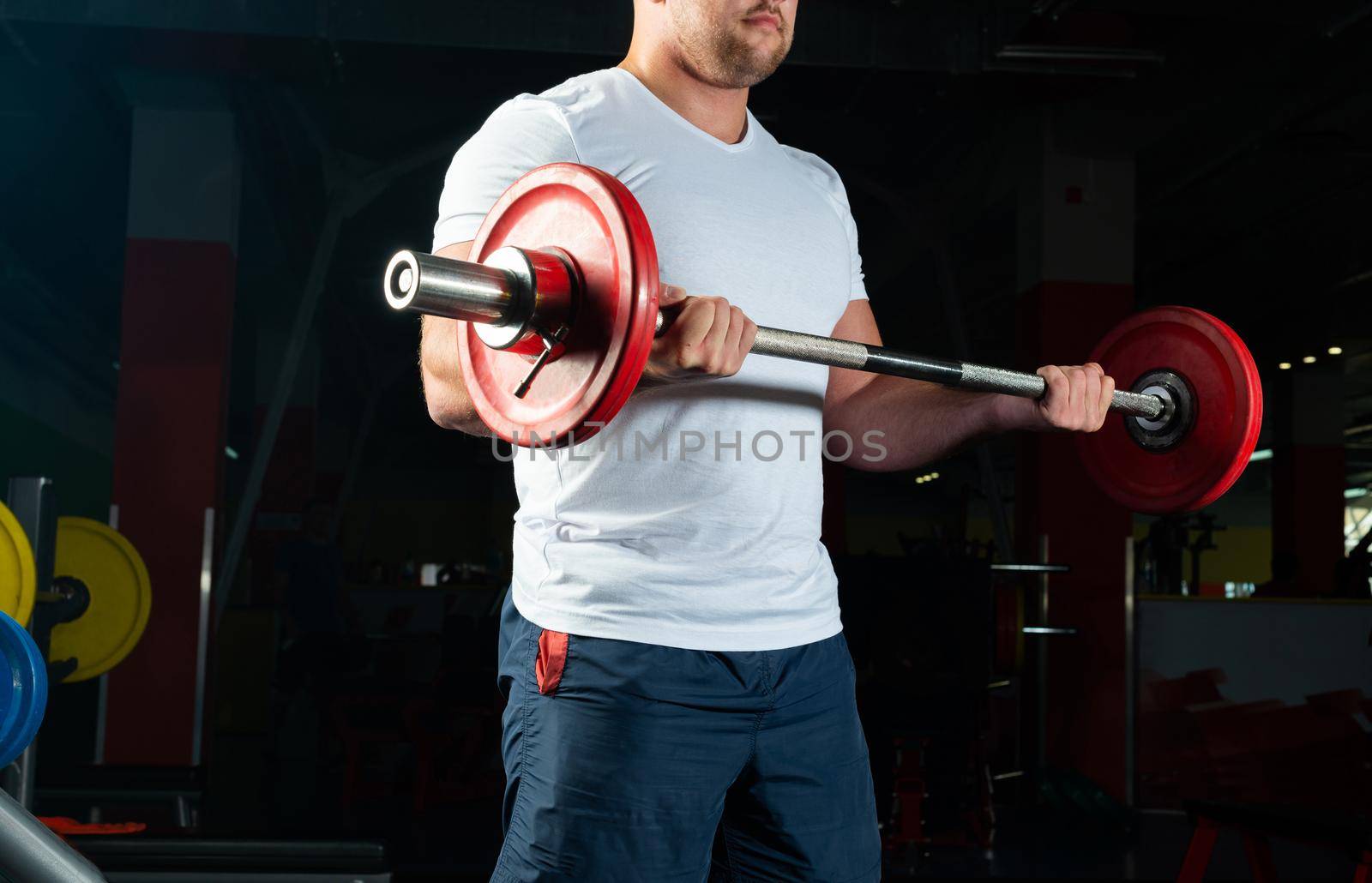 Man in the gym lifts the barbell. bodybuilding and healthy lifestyle