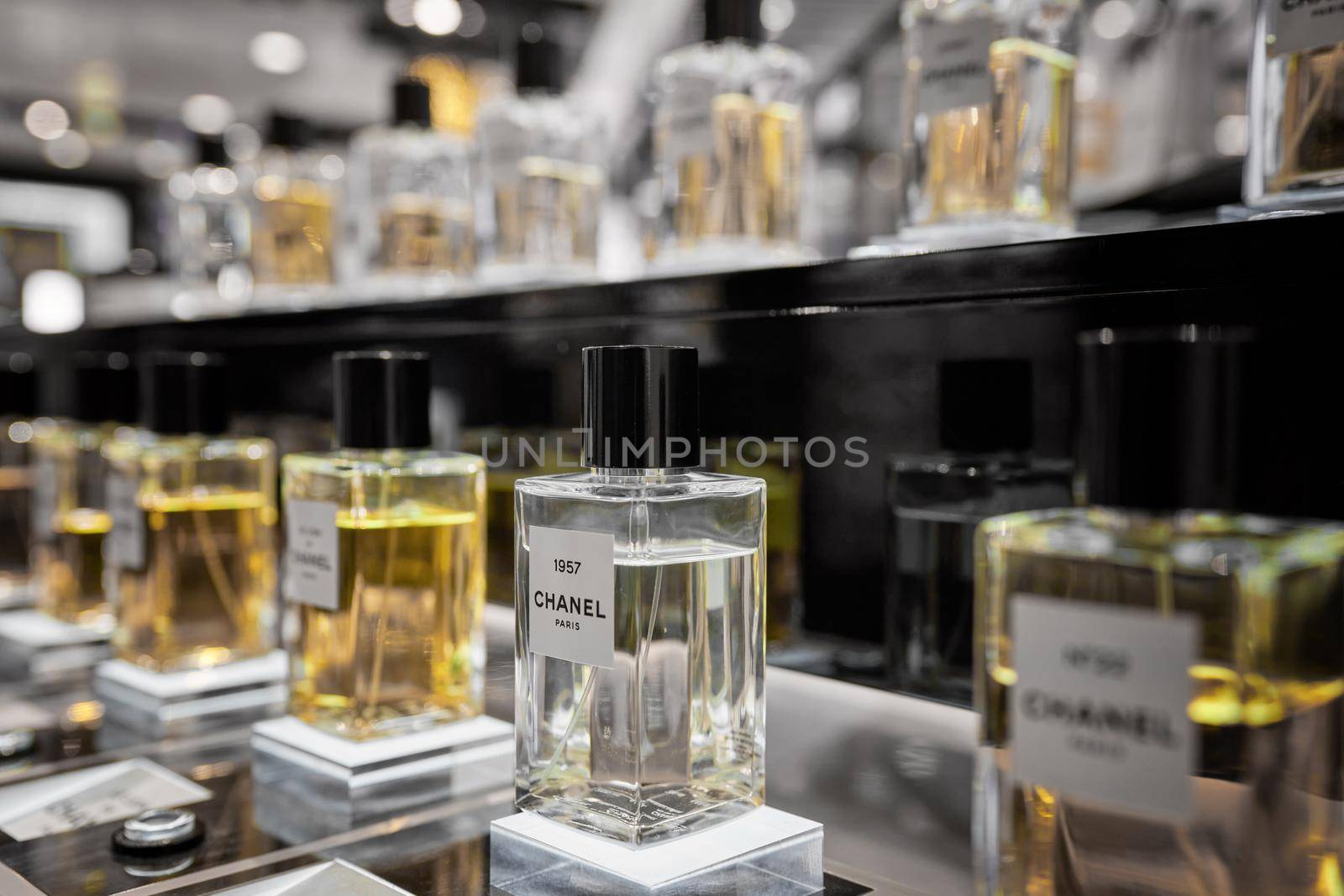 Female perfume Chanel No. 22 bottle closeup in store showcase. Perspective view of french Chanel perfume collection. Milan, Italy - December 15, 2020. by photolime