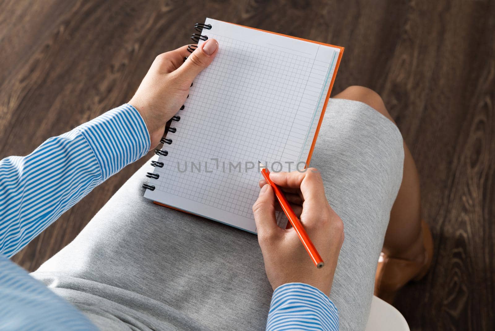 close-up a female hands with notebook and pencil