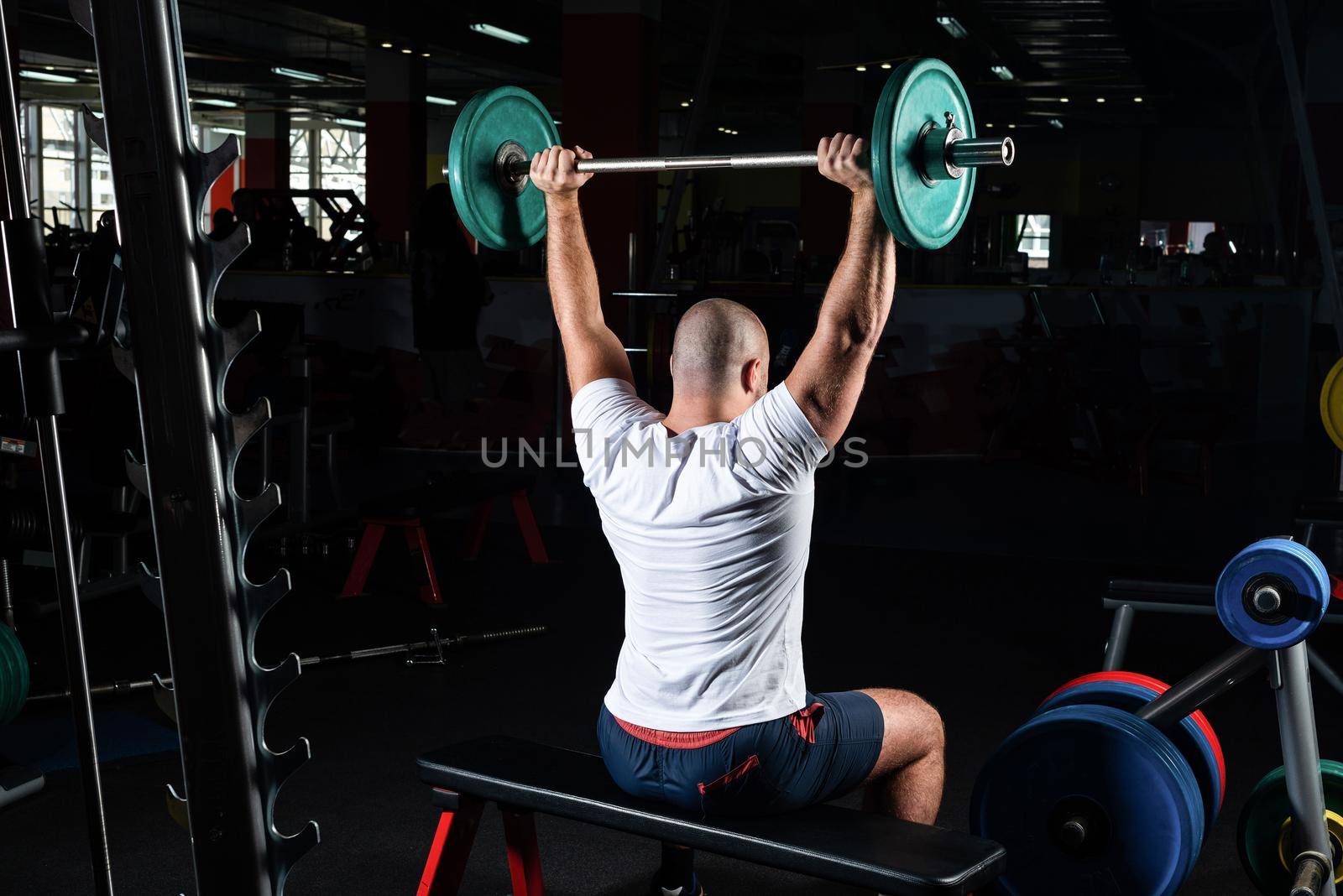 Man in the gym lifts the barbell. bodybuilding and healthy lifestyle