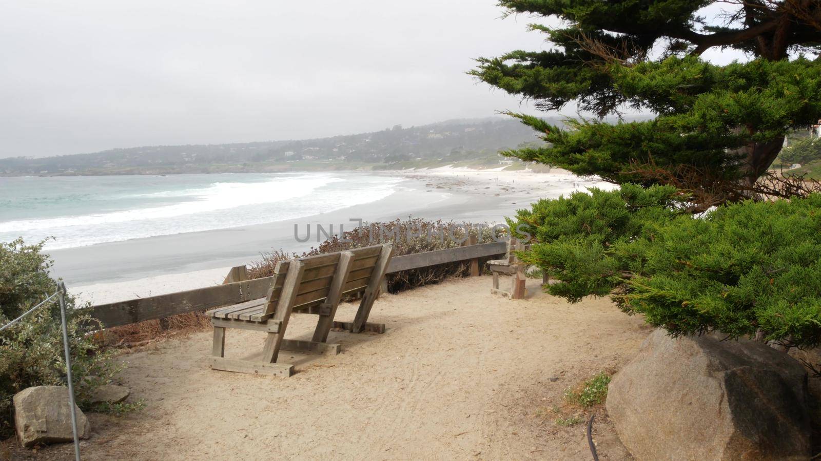 Empty wooden bench, rest on footpath trail. Ocean beach, California coast, trees by DogoraSun