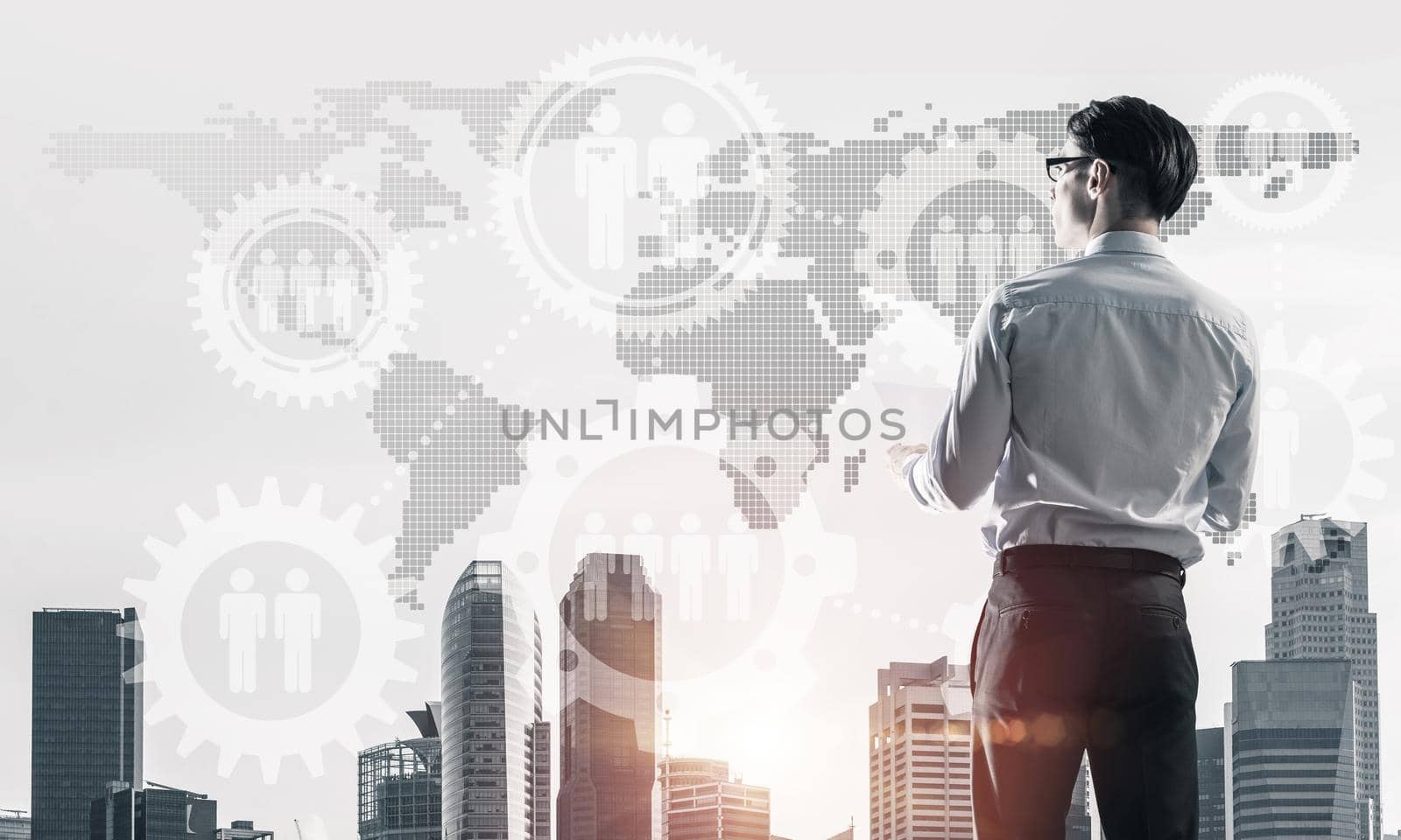 Young elegant businessman standing with back looking at business city