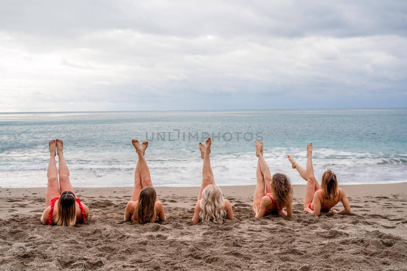 Big happy family or group of five friends is having fun against sunset beach. Beach holidays concept. by Matiunina