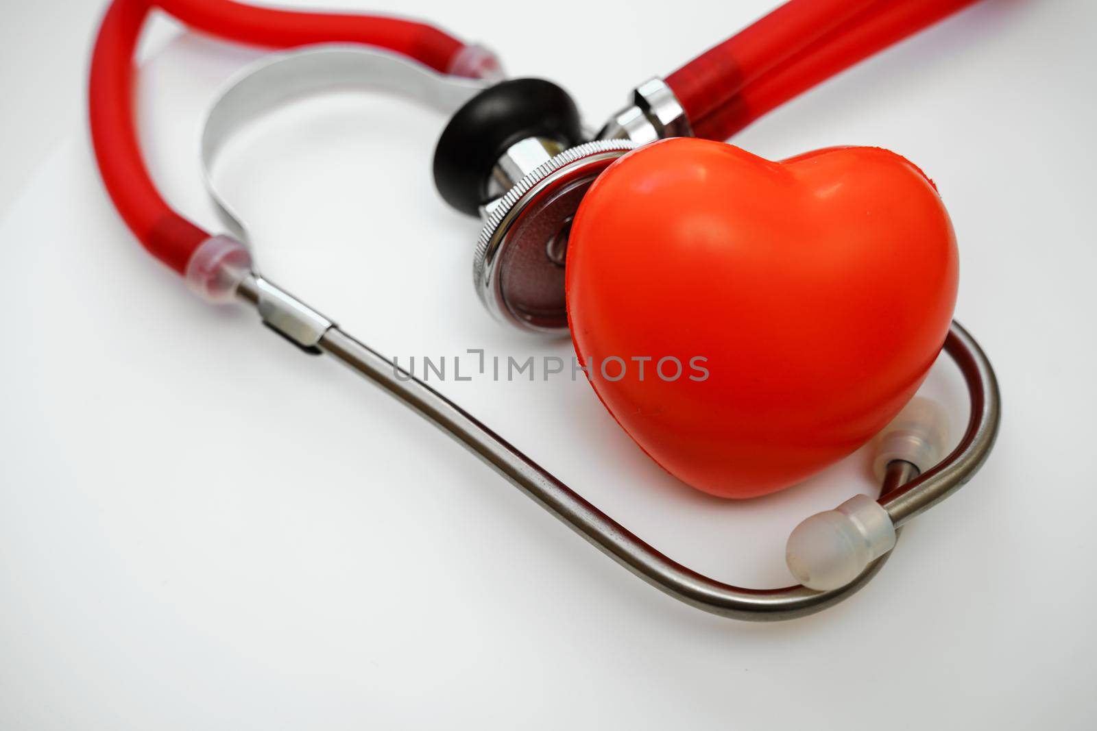 Stethoscope and red heart on white background, heart health, health insurance concept.