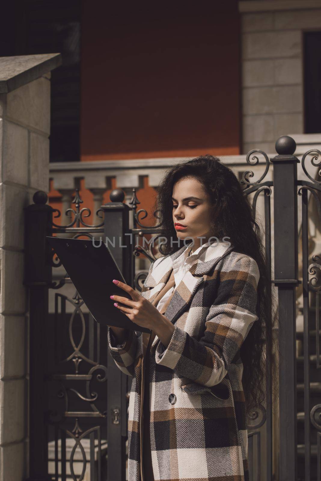 Female real estate agent with clipboard outdoors by Ashtray25