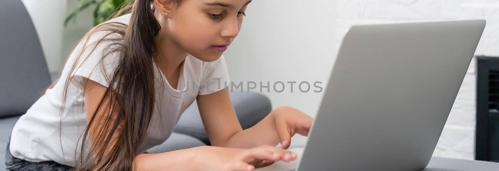 little girl studying with computer, little girl with laptop online