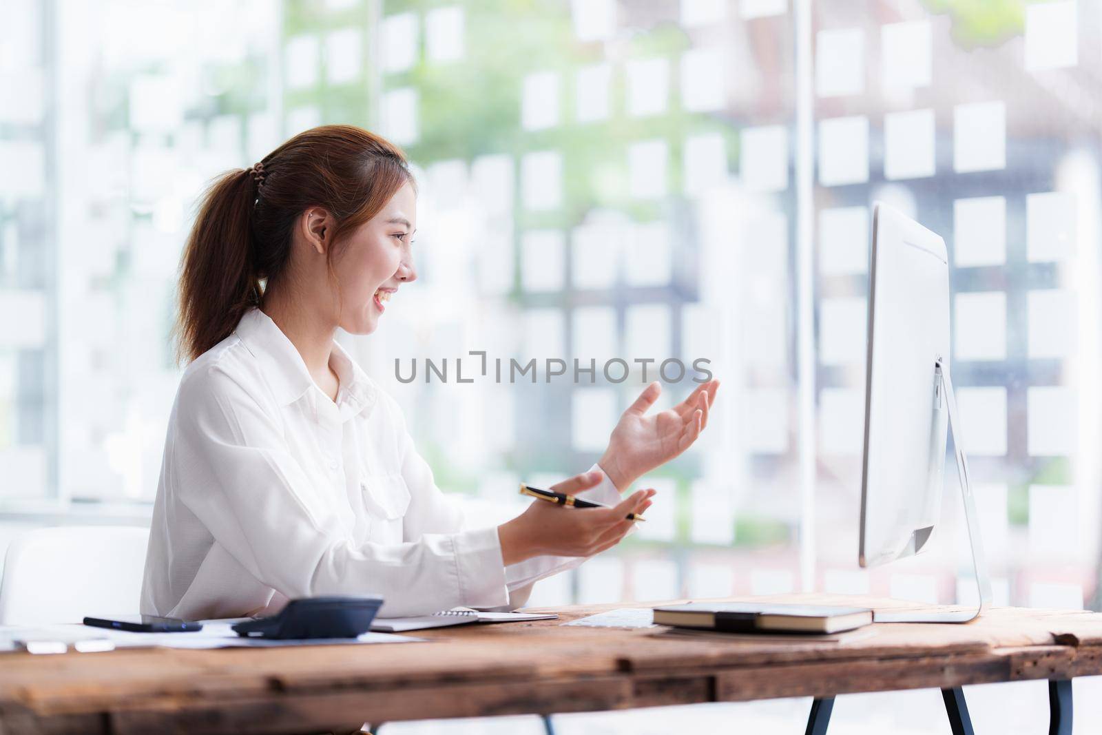 Job interview concept. Business woman questioning and listen to candidate answers during interview by video call on desktop computer