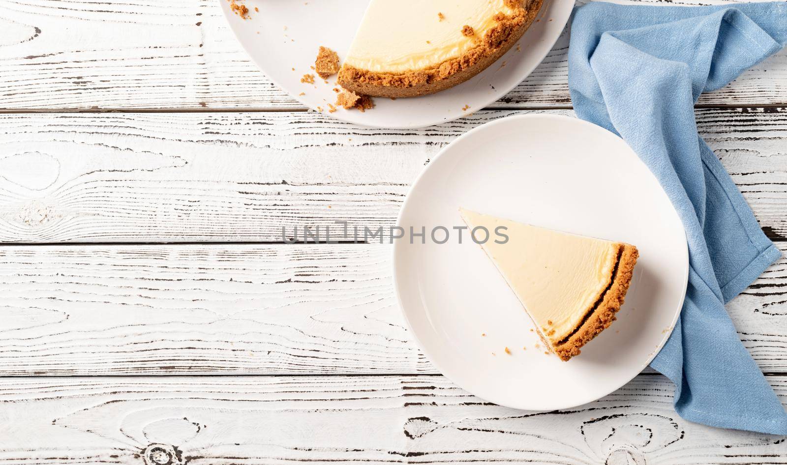 Tasty homemade cheesecake on white wooden table with copy space