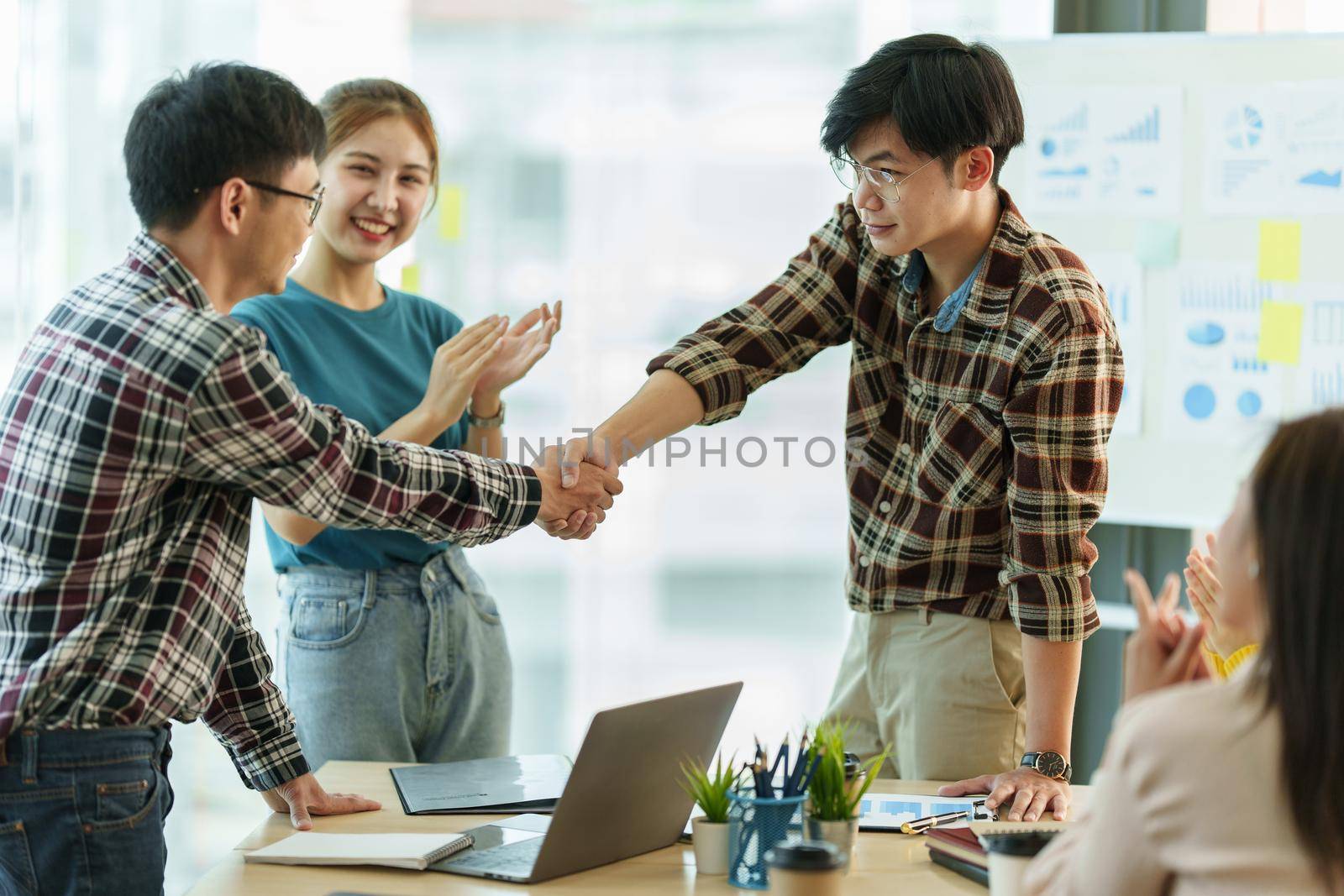 Business people successful negotiation and handshake. celebration partnership and teamwork, business deal concept. by itchaznong