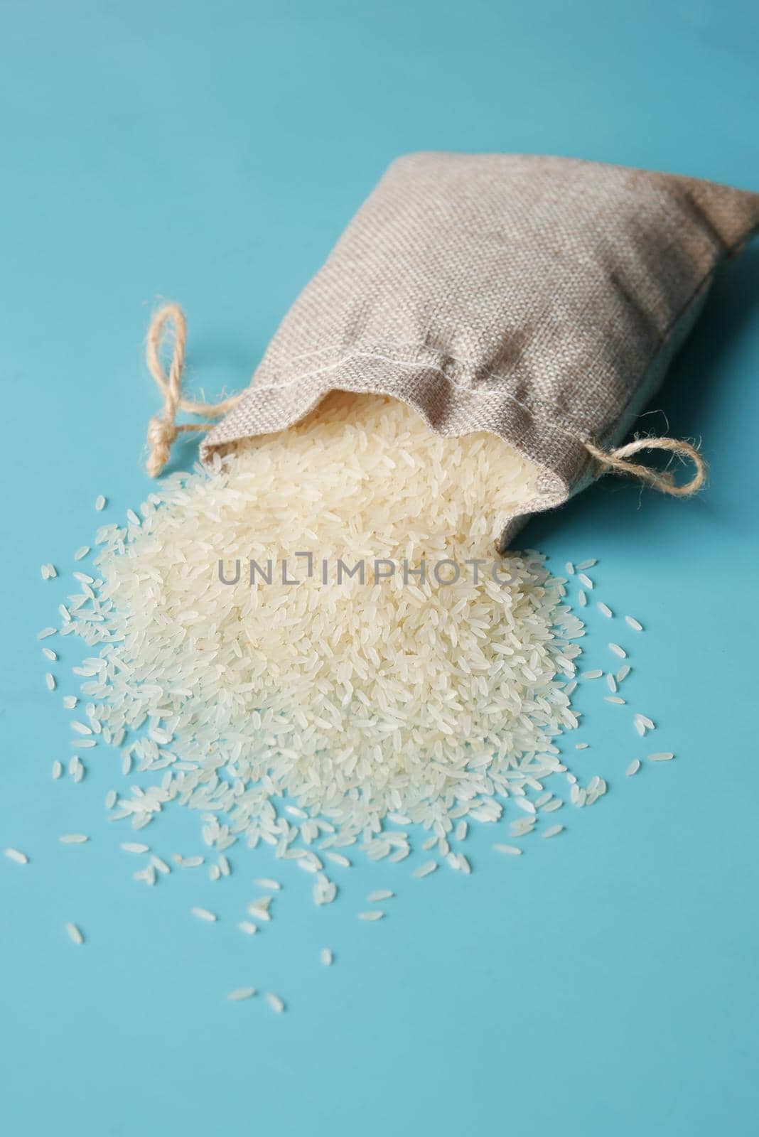 Rice in a bag on table cloth, Top view. by towfiq007