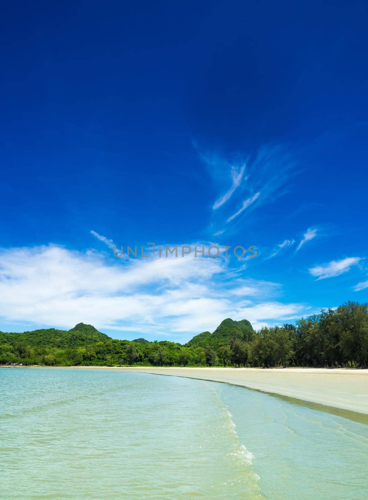 Wide view of beach, sea and the mountain with blue sky background