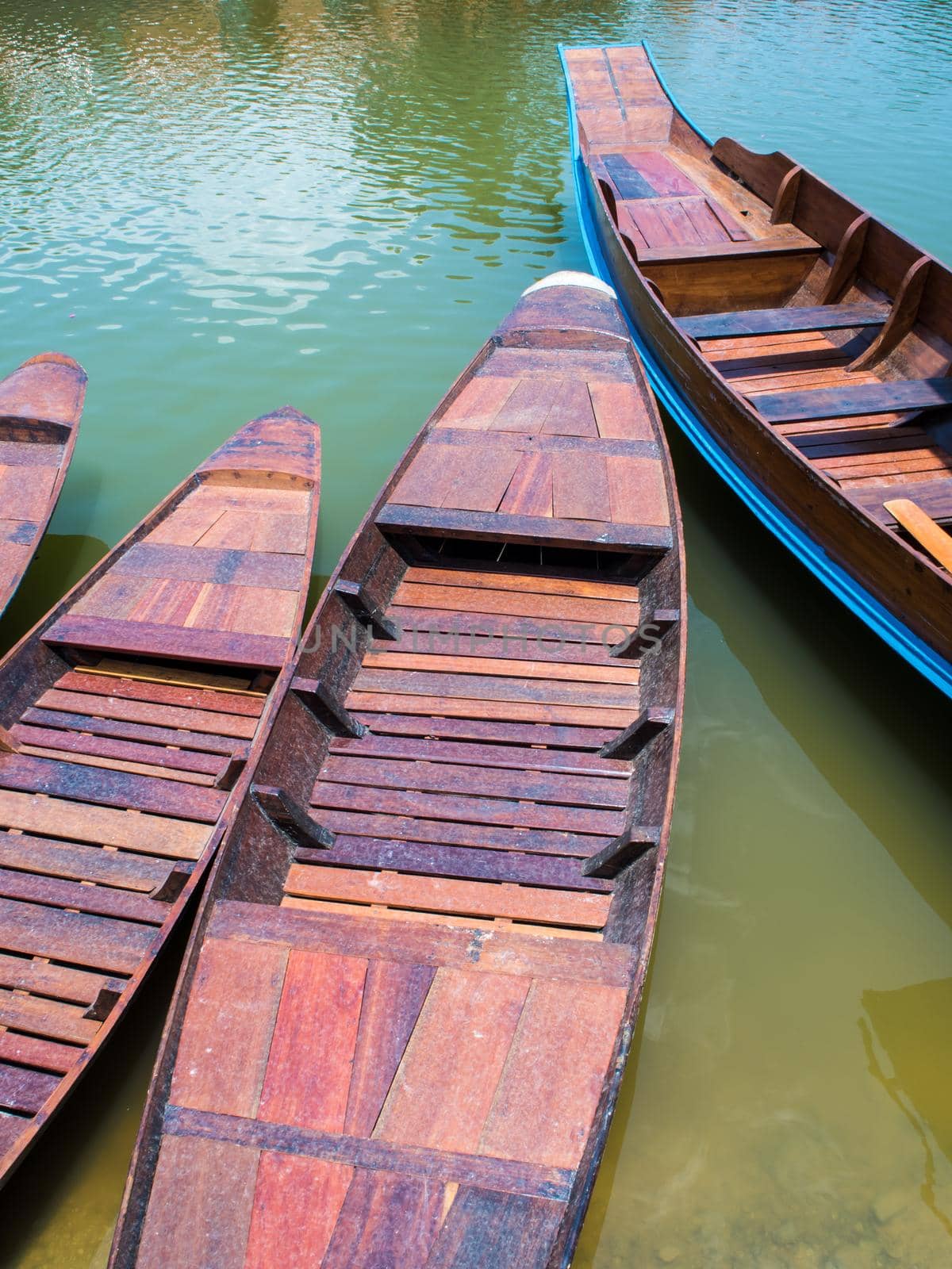 Wooden boat float in lake by Satakorn