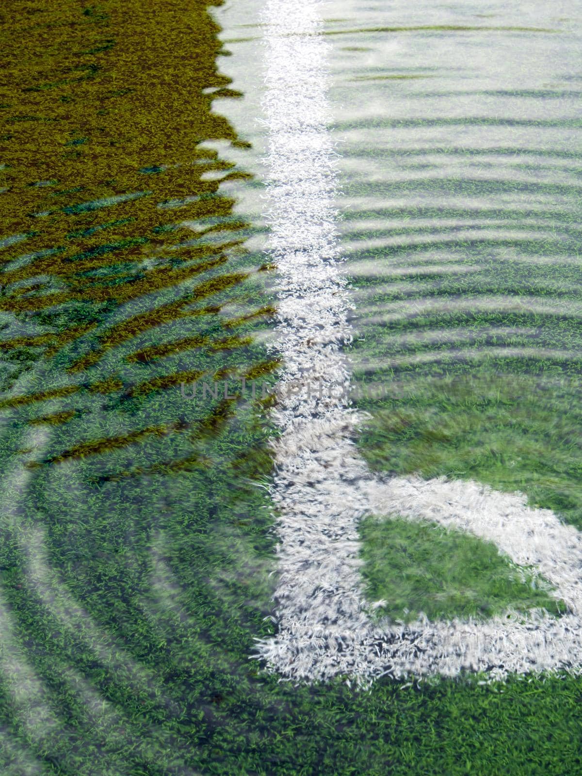 Flooding in artificial grass football field by Satakorn