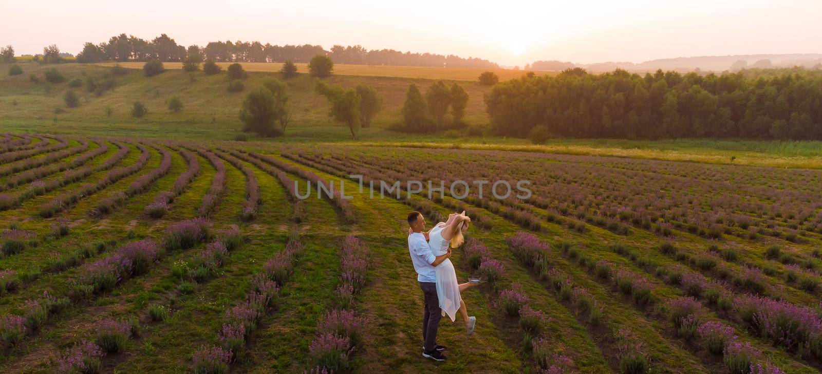 Young couple playing around in the lavender fields by Andelov13