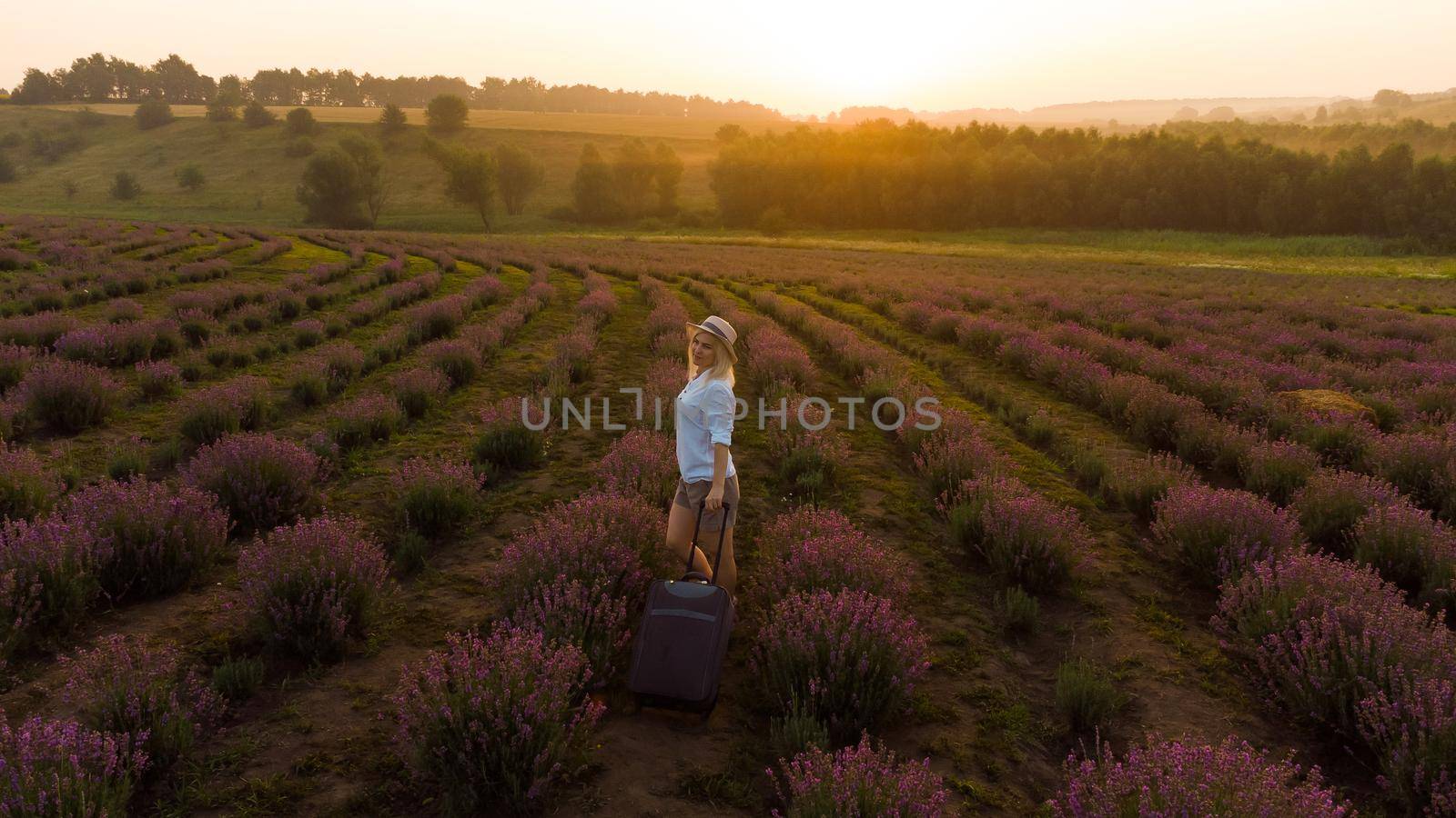 women with a suitcase and lavender field