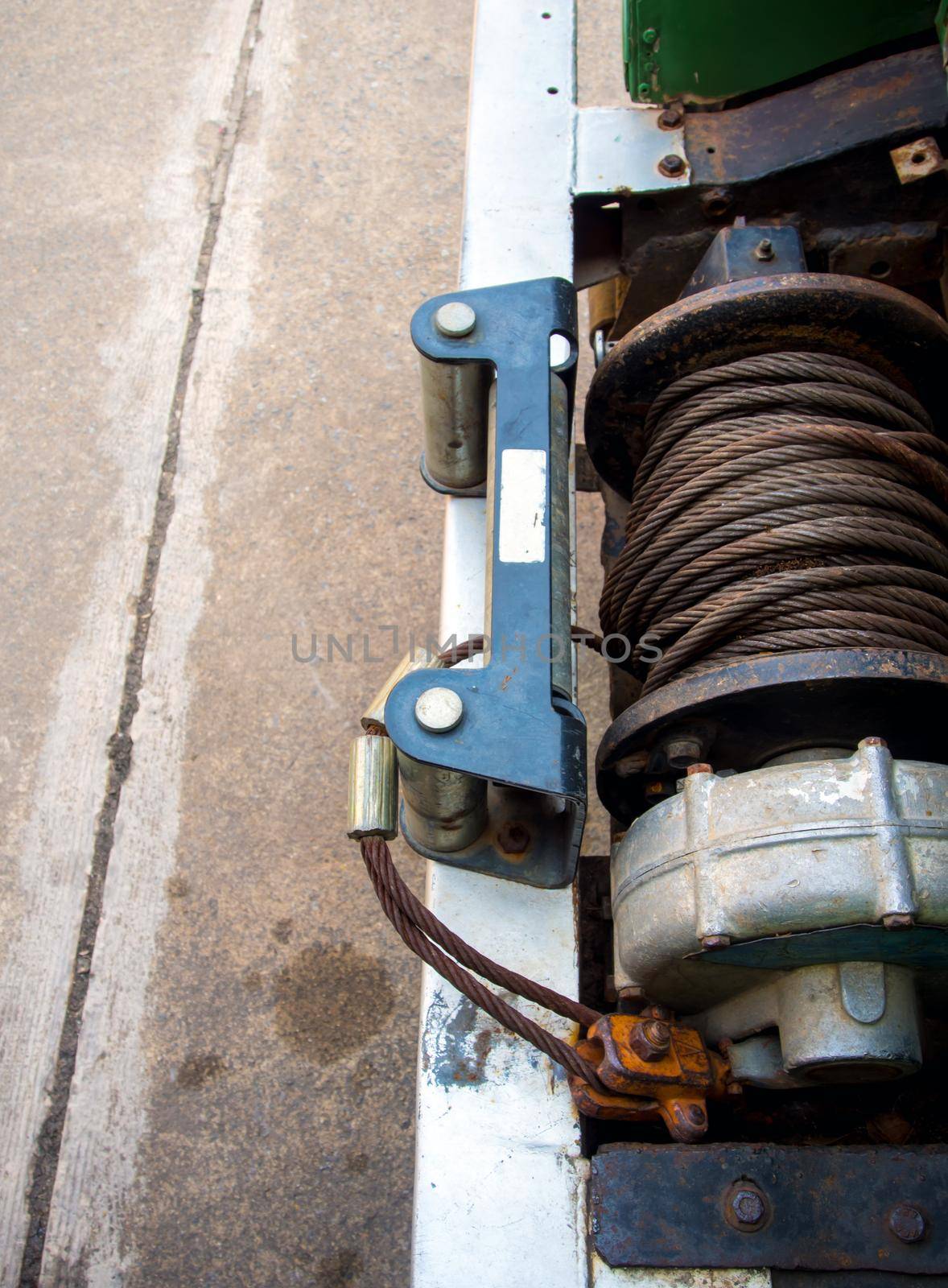 Old sling cable of electric winch in front of 4x4 car