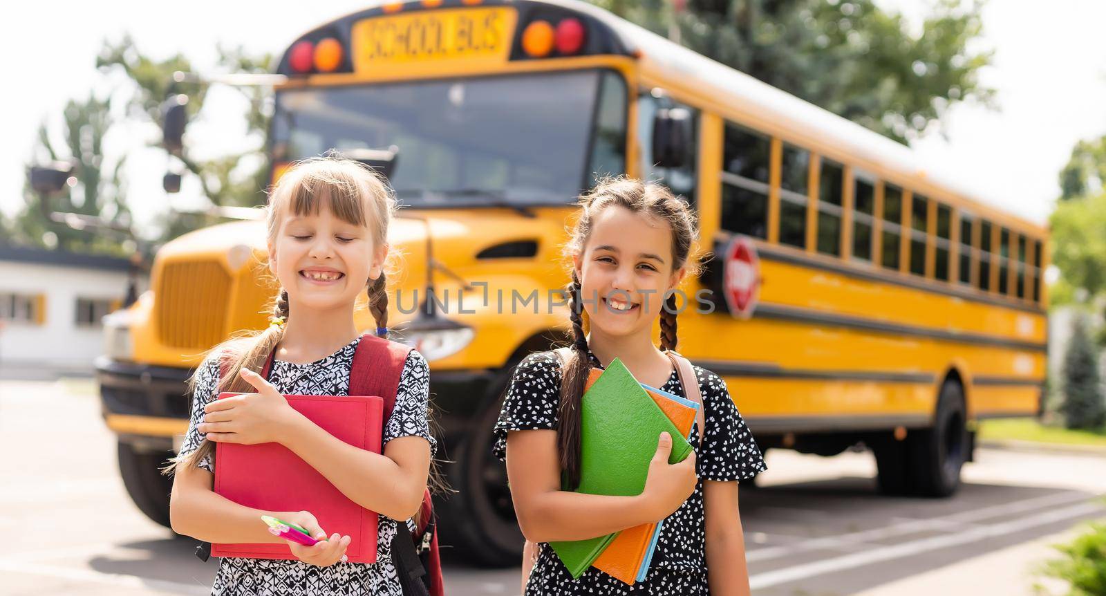 Education: Smiling Student Friends Ready For School next to school bus by Andelov13